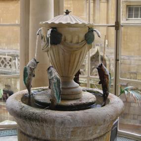 Colour photograph of a fountain in the Grand Pump Room in Bath, offering the curative Bath waters which provided Mary Chandler's livelihood and were the central subject of her poem.