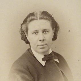 Albumen carte-de-visite of Emily Faithfull taken some time in the mid to late 1860s. (A carte-de-visite was a photo in the small size of the visiting card.) She is wearing a single-button jacket with white shirt collar and bow tie, looking quite sharp. Her hair is parted in the middle and slicked to the sides.